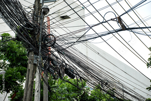 Tangle of Electrical cables and Communication wires on electric pole.
