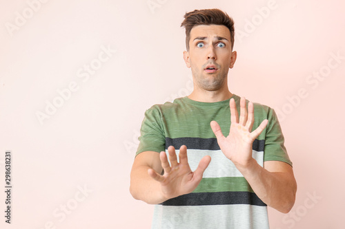 Shocked young man on color ...