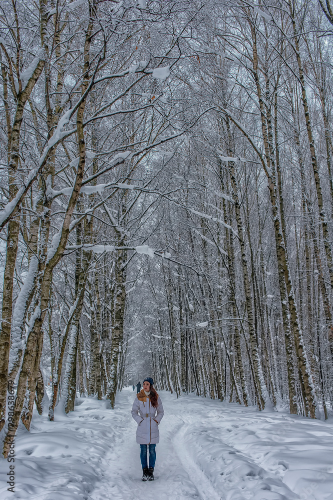 girl on a forest road in winter