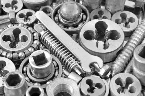 Mechanical ratchets nuts and bolts closeup, toned image photo