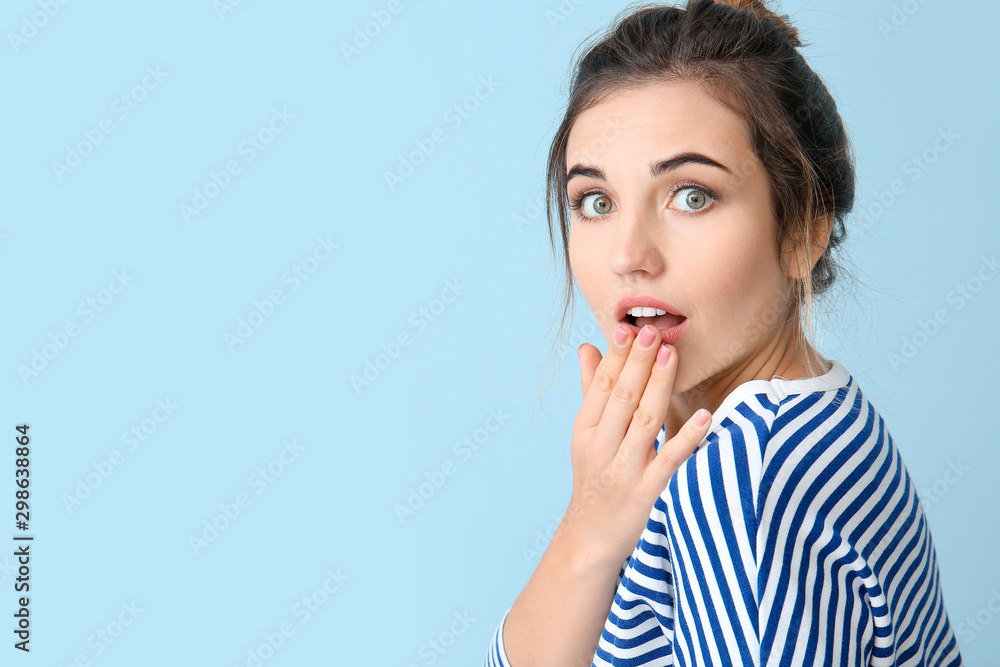 Surprised young woman on color background Surprised young woman on color background
