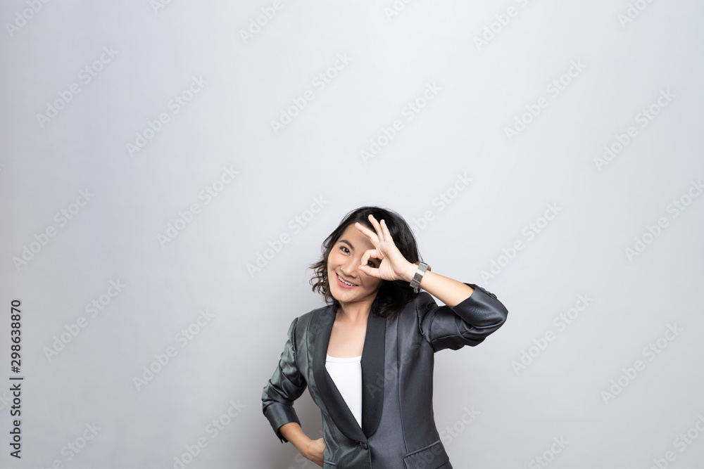 Happy woman showing OK gesture isolated on background Happy woman showing OK gesture isolated on background