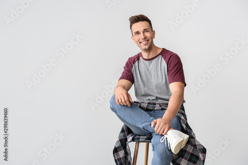 Portrait of stylish young man on light background