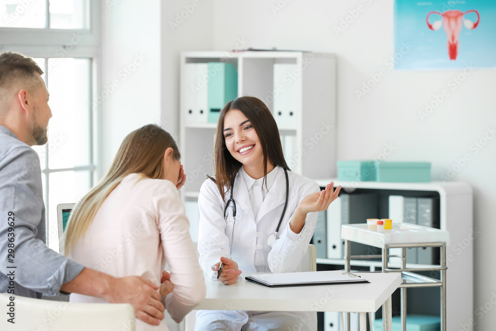 Couple visiting female gynecologist in clinic