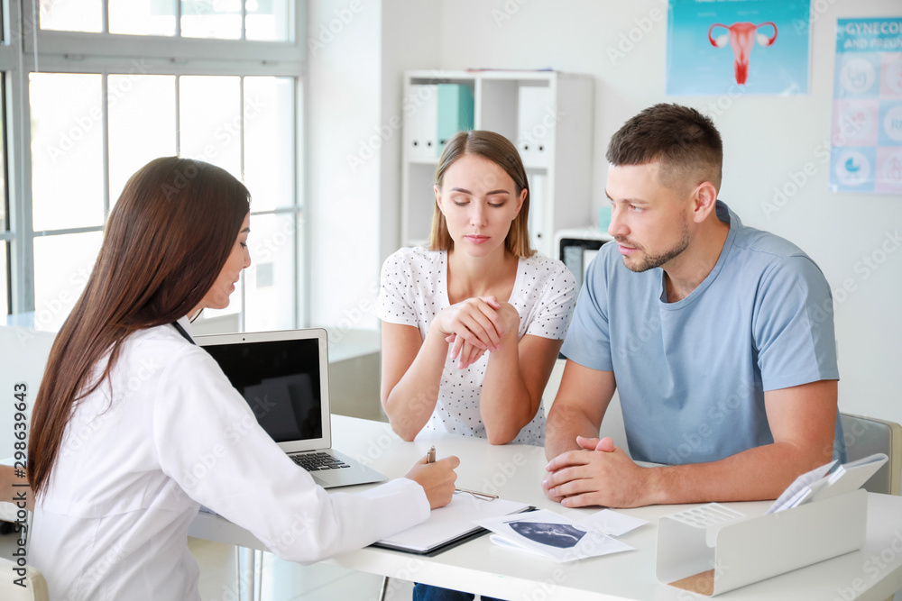 Fototapeta premium Couple visiting female gynecologist in clinic