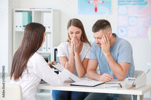 Sad couple at a gynecologist appointment in clinic
