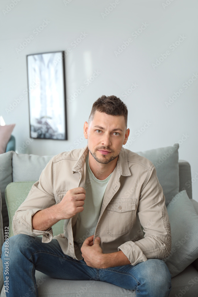 Portrait of handsome man sitting on sofa at home Portrait of handsome man sitting on sofa at home