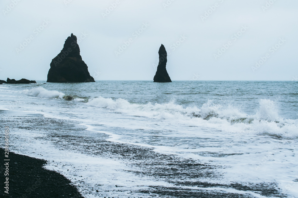 Reynisfjara rocks in storm, Atlantic ocean coast in Iceland