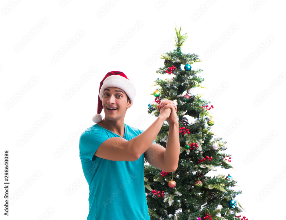 Young man decorating christmas tree isolated on white Young man decorating christmas tree isolated on white