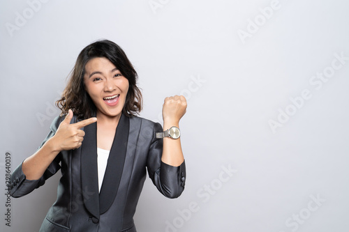 Happy woman holding hand with wrist watch