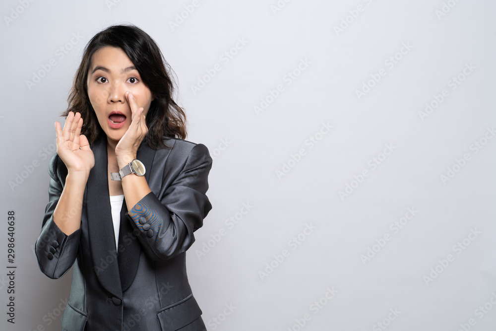 Woman make whisper gesture isolated over white background Woman make whisper gesture isolated over white background