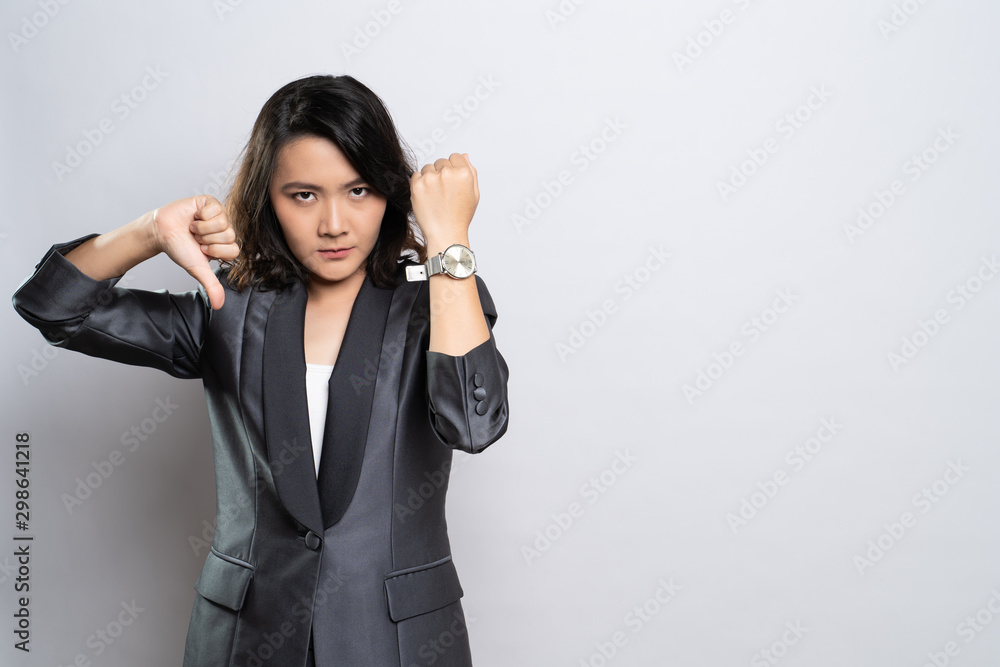 Angry woman pointing at her watch Angry woman pointing at her watch