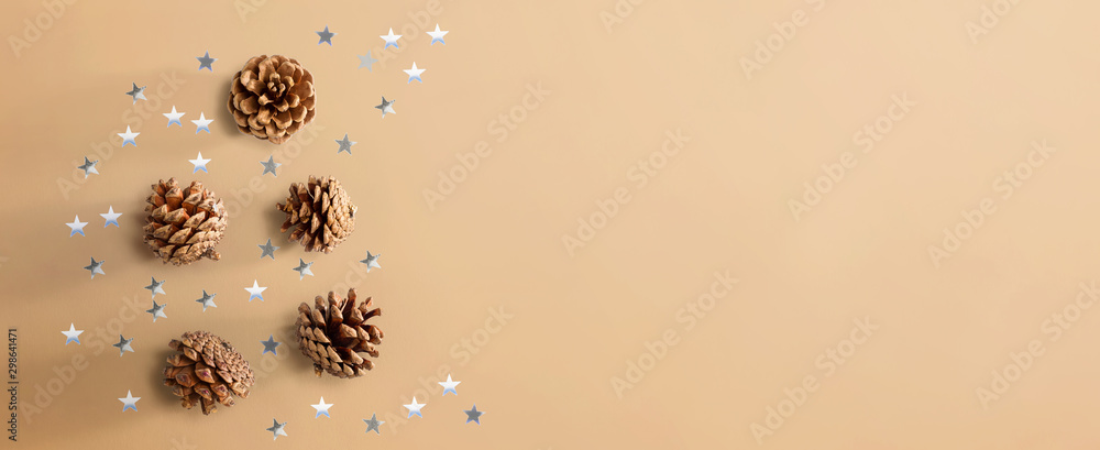 Christmas pinecones with star confetti - flat lay
