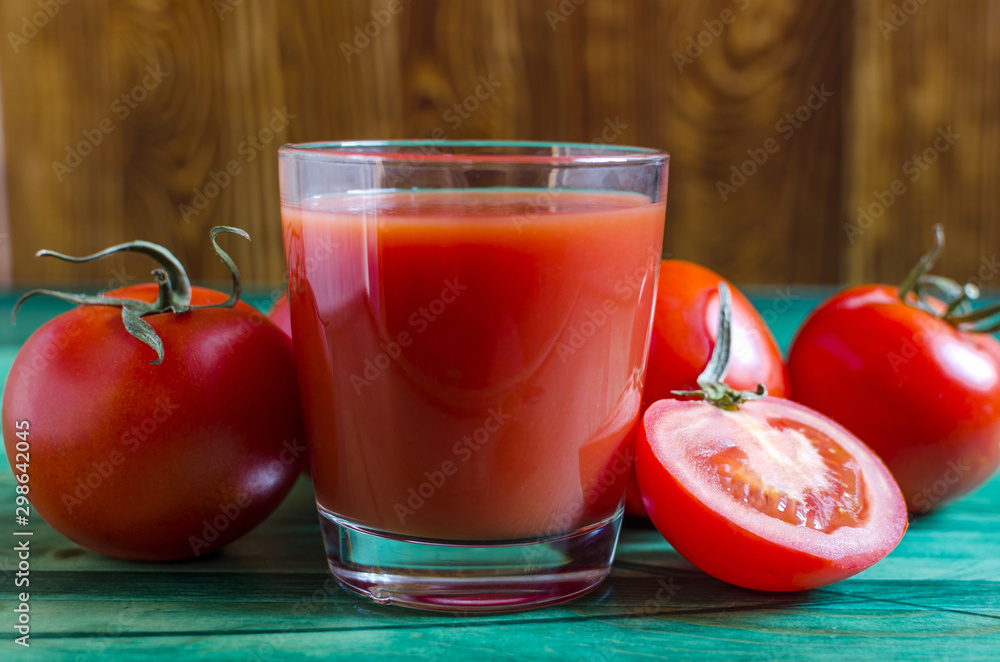 Tomato juice in a transparent bowl and tomatoes are healthy food Tomato juice in a transparent bowl and tomatoes are healthy food