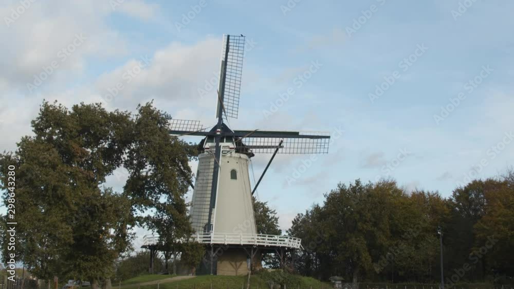 Tilting down from blue sky to beautiful traditional windmill - medium shot Tilting down from blue sky to beautiful traditional windmill - medium shot
