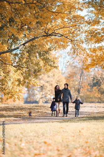 Fototapeta Naklejka Na Ścianę i Meble -  Family walk in autumn park