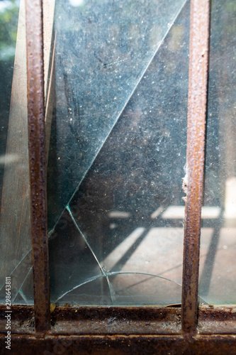 Blurred broken dust Glass door texture background, Rusty metal frame, Close up shot, Selective focus, Reflection, Home decor repair concept