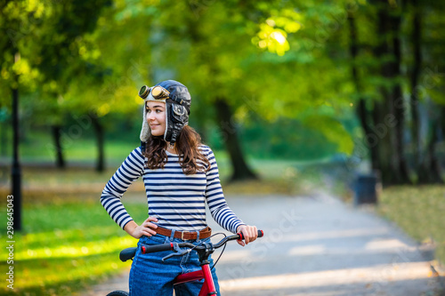 Woman standing with bike in city park