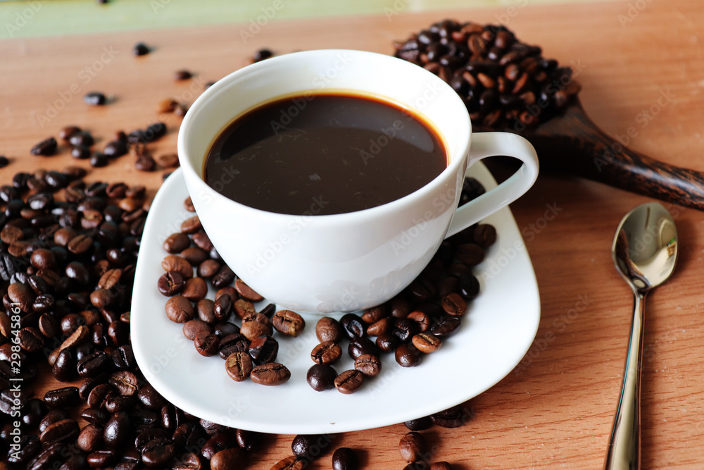 cup of coffee and beans on wooden table