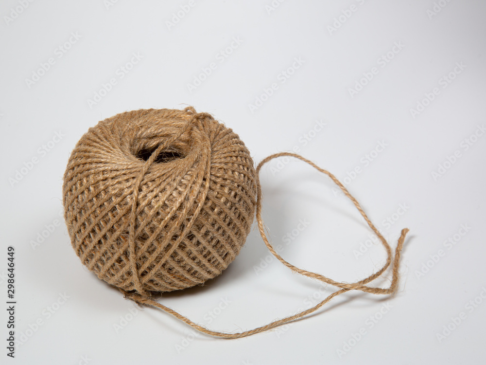 a partly uncoiled ball of string isolated on white background a partly uncoiled ball of string isolated on white background