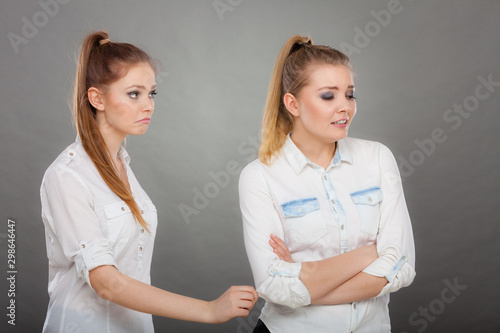 woman asking apologize to her offended friend after quarrel. photo