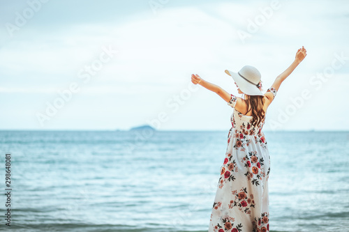 Travel woman walking on beach