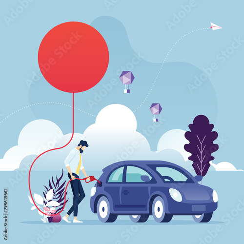 Renewable energy concept-Businessman fueling a car using energy of the sun