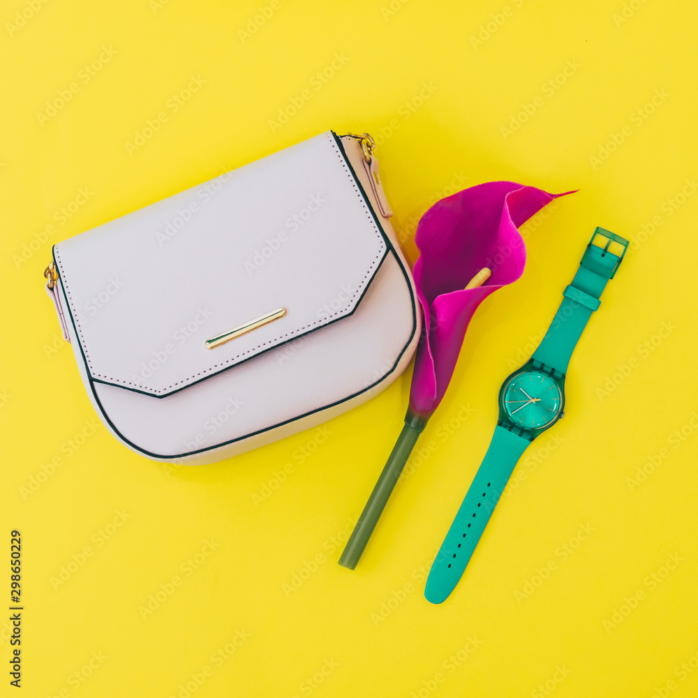 Fotografie Minimalistic fashionable and stylish flat lay set of pink bag, lilly flower and
