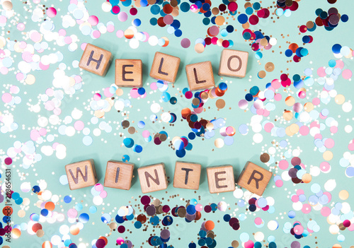 Hello winter word written on wood block. Greeteng card concept on mint background. © rodjulian