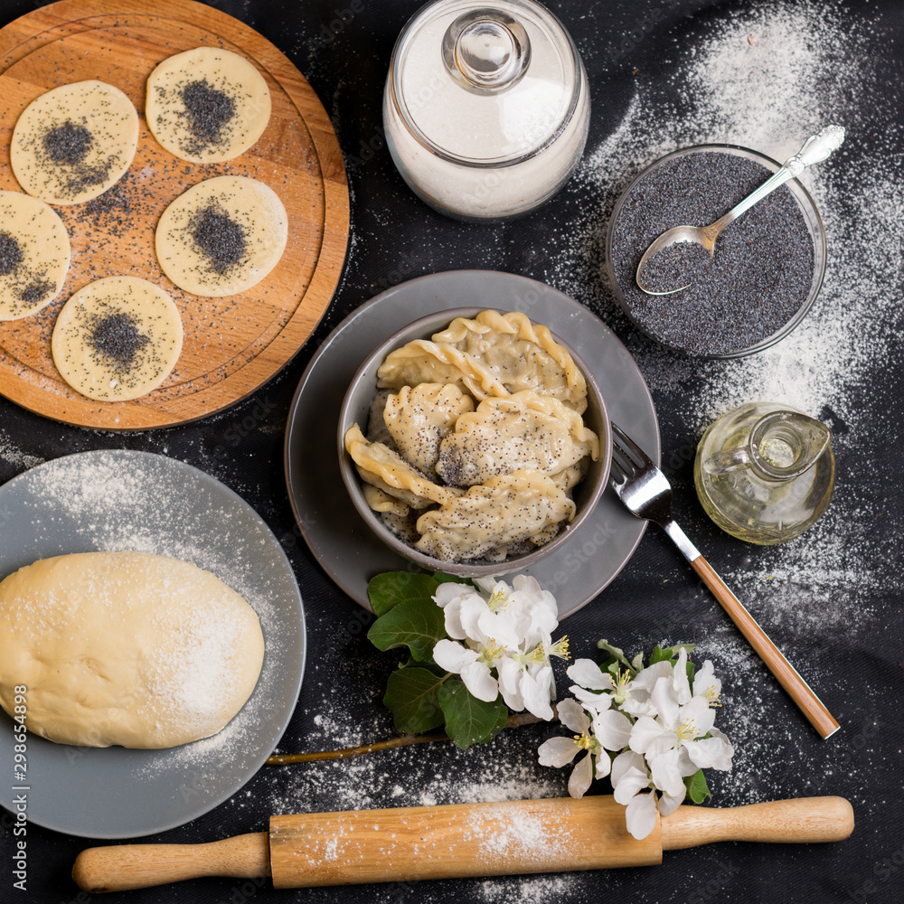 vareniki and ingredients on a black background vareniki and ingredients on a black background