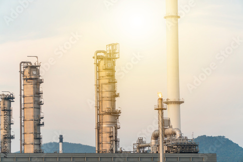 concept of industrial or Oil refinery or Pollution and environment. shot of Oil and gas refinery plant form industry petroleum zone,Refinery equipment pipeline steel and oil storage tank at sunset