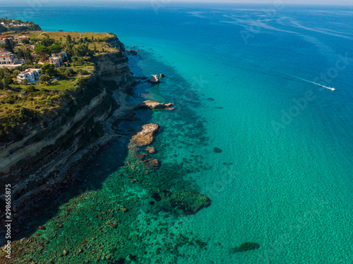 Aerial view of the Calabrian coast, cliffs overlooking the crystal clear sea and luxury villas. Locality of Riaci south of Tropea. Calabria. Italy