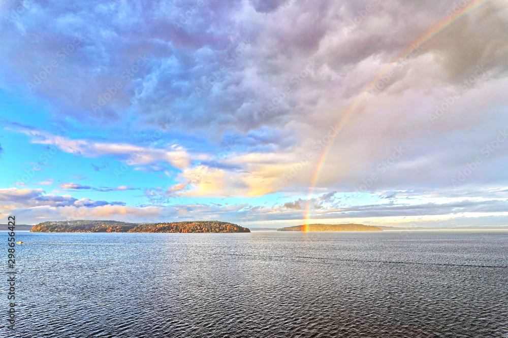 Fototapeta Colorful views of the rainbow against the sky, clouds and sea horizon. Commencement Bay,Tacoma,USA      A.
