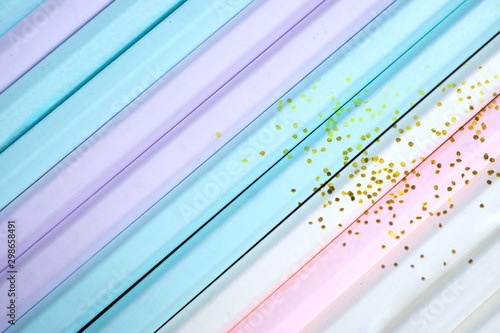 Colorful pastel plank background from wooden pencil with golden gliter..