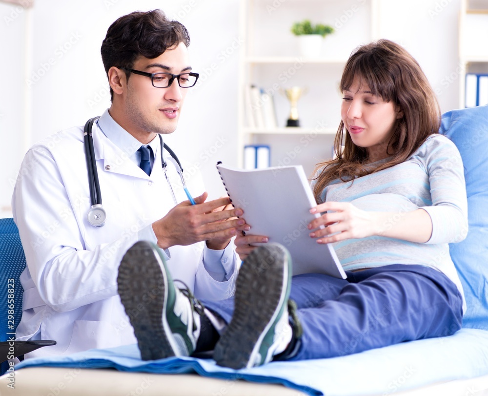 The pregnant woman visiting doctor for consultation The pregnant woman visiting doctor for consultation