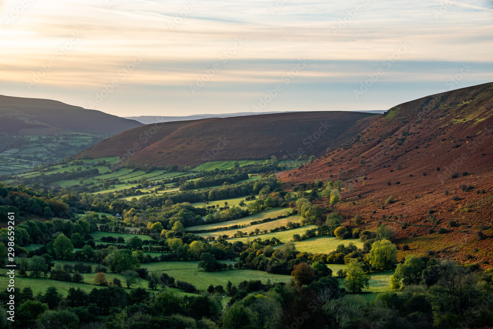 Scenic landscape view from Mynydd Troed in to a valley in autumn during sunrise