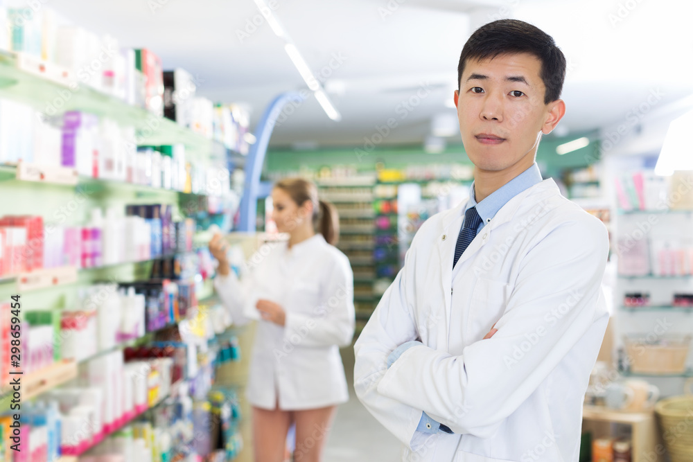 japanese male specialist who is standing in pharmacy