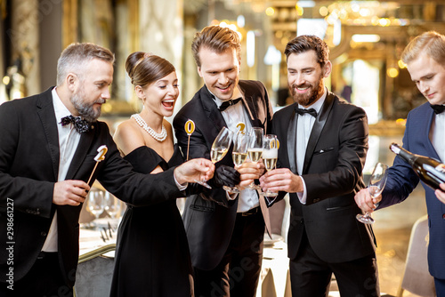 Well-dressed people celebrating New Year indoors photo