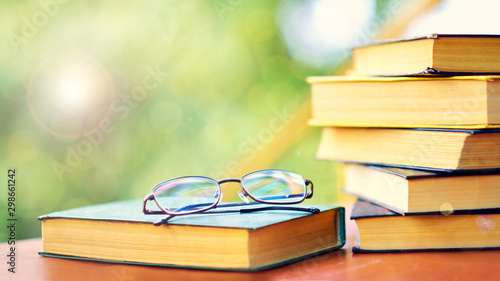 glasses and open book. best books home library background. read vintage books in a row. college library table. publishing