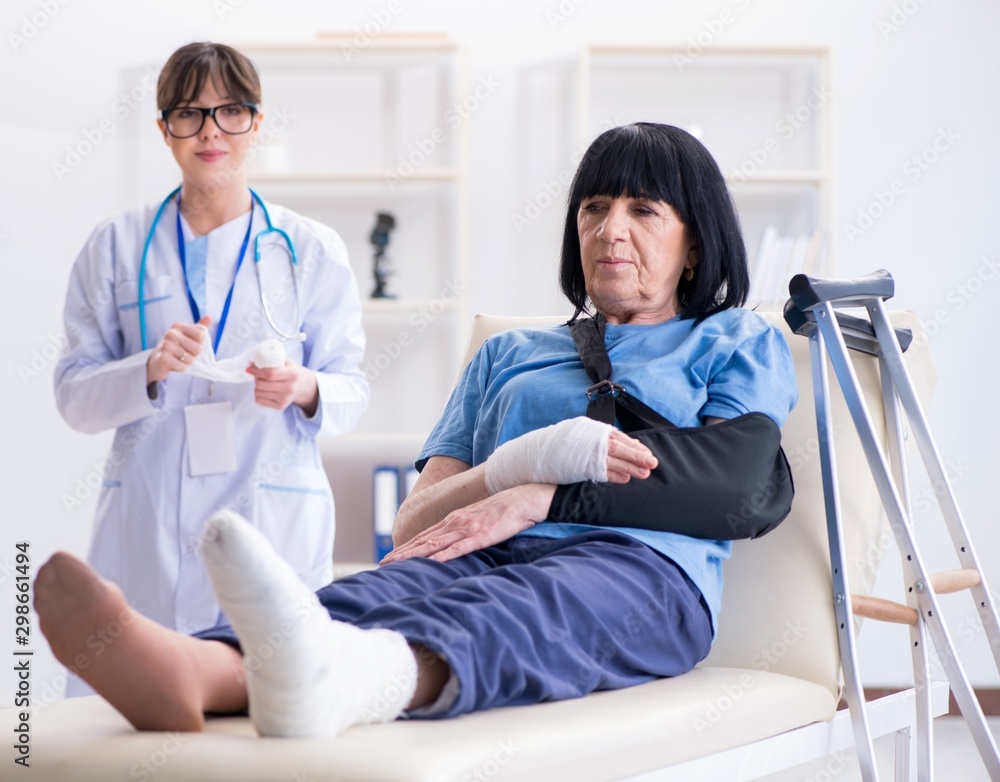 Doctor examining old mature woman after incident Doctor examining old mature woman after incident