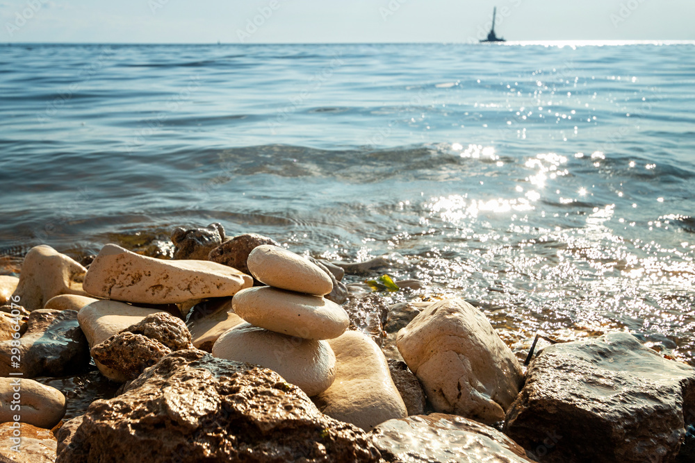 Shoreline with water and rocks, peaceful and zen-like picture - obrazy, fototapety, plakaty 