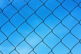 Black metal mesh on the background and blue sky 