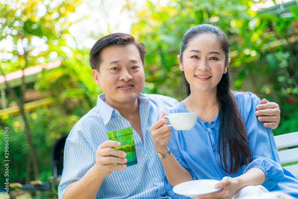 Elder retirement couple drinking coffe and talking in park Elder retirement couple drinking coffe and talking in park