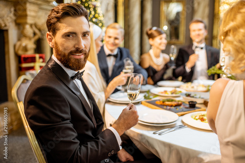 Man with friends during a festive dinner on New Years Eve