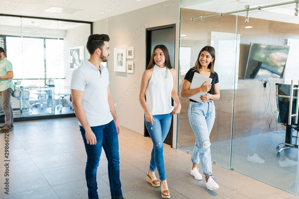 Fototapeta premium Coworkers Walking Together In Corridor At Office