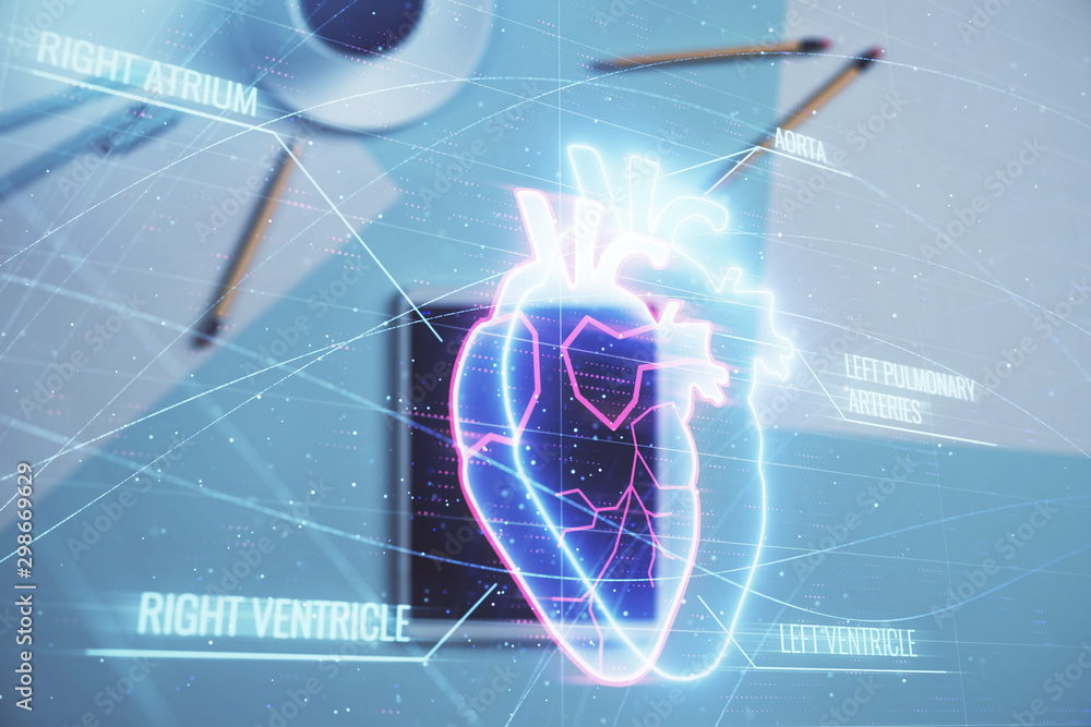 Double exposure of heart hologram on digital tablet, table background. Concept of medical education