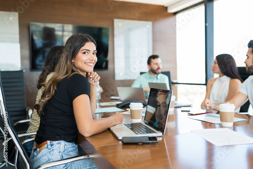 Beautiful Businesswoman With Team In Meeting Room