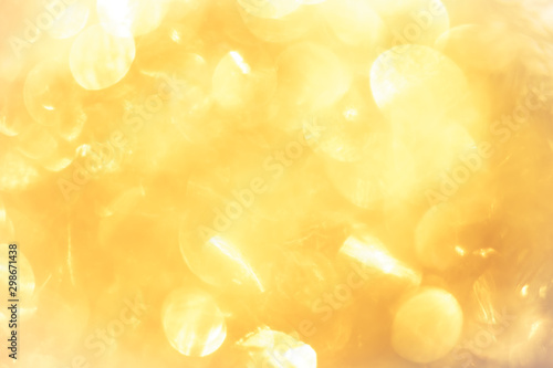 golden color blurred abstract background. yellow bokeh christmas blurred beautiful shiny Christmas lights. photo