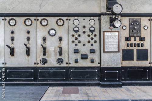 Dials and switches in the control room in old power plant. Control panel with measuring instruments