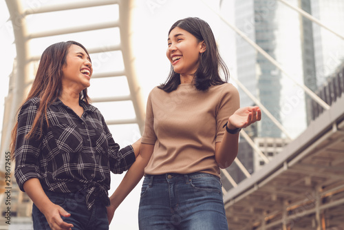 Obraz na plátně Multicultural Asian girlfriends having social time together on city holiday vaca